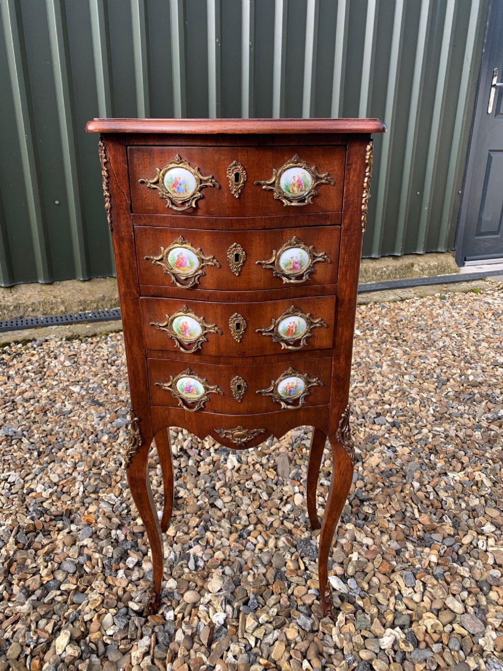 A good quality French mahogany serpentine chest with porcelain plaques
