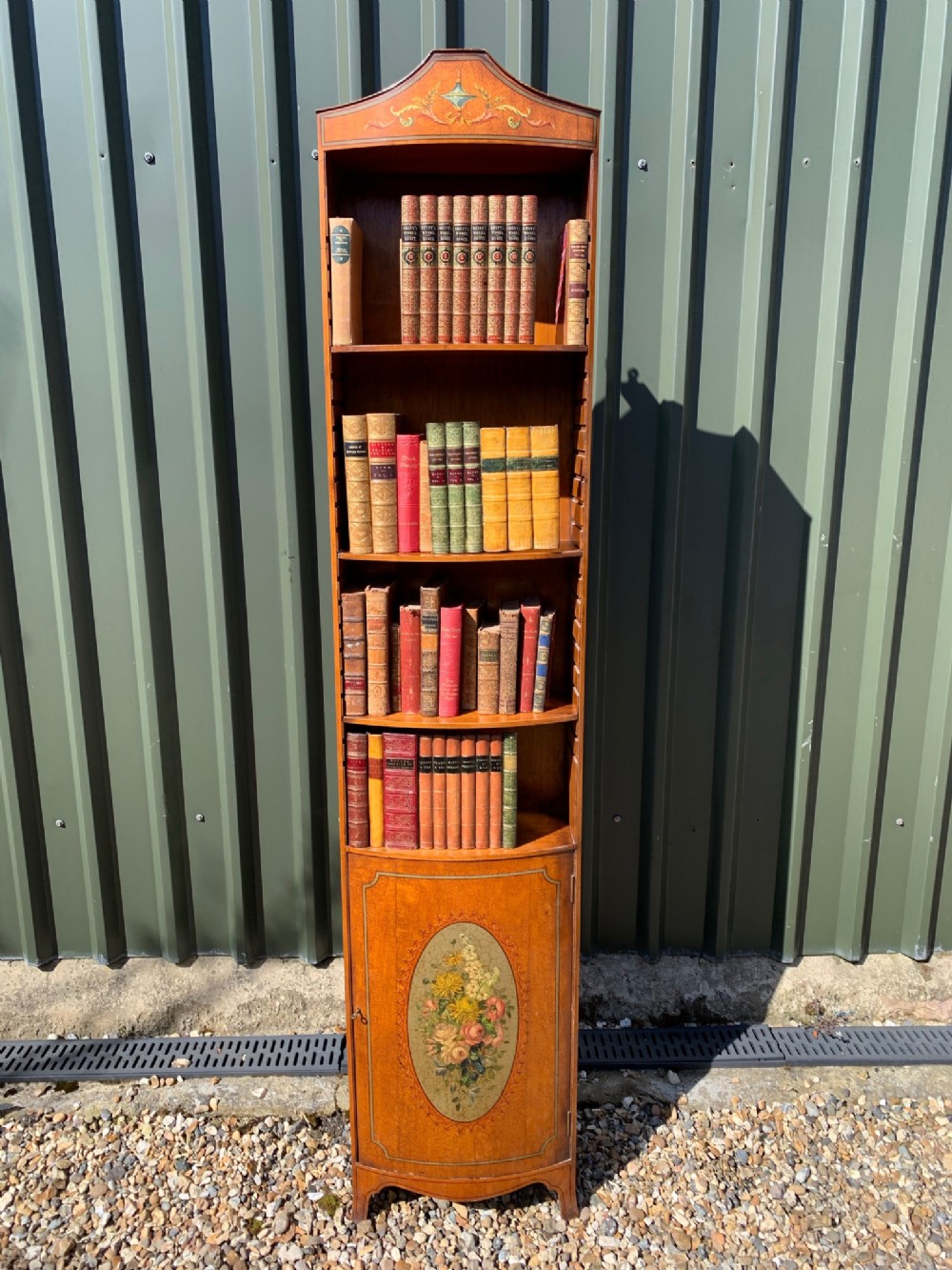 A Sheraton Revival satinwood painted bookcase.