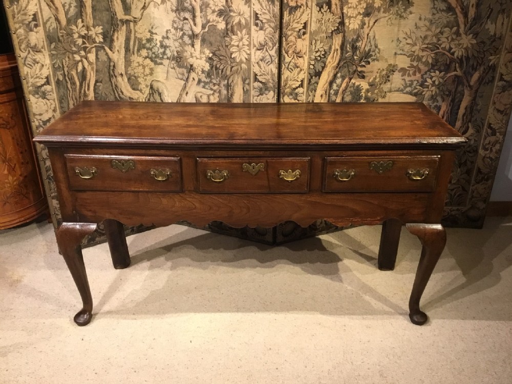 An elm George III Period cabriole leg dresser base