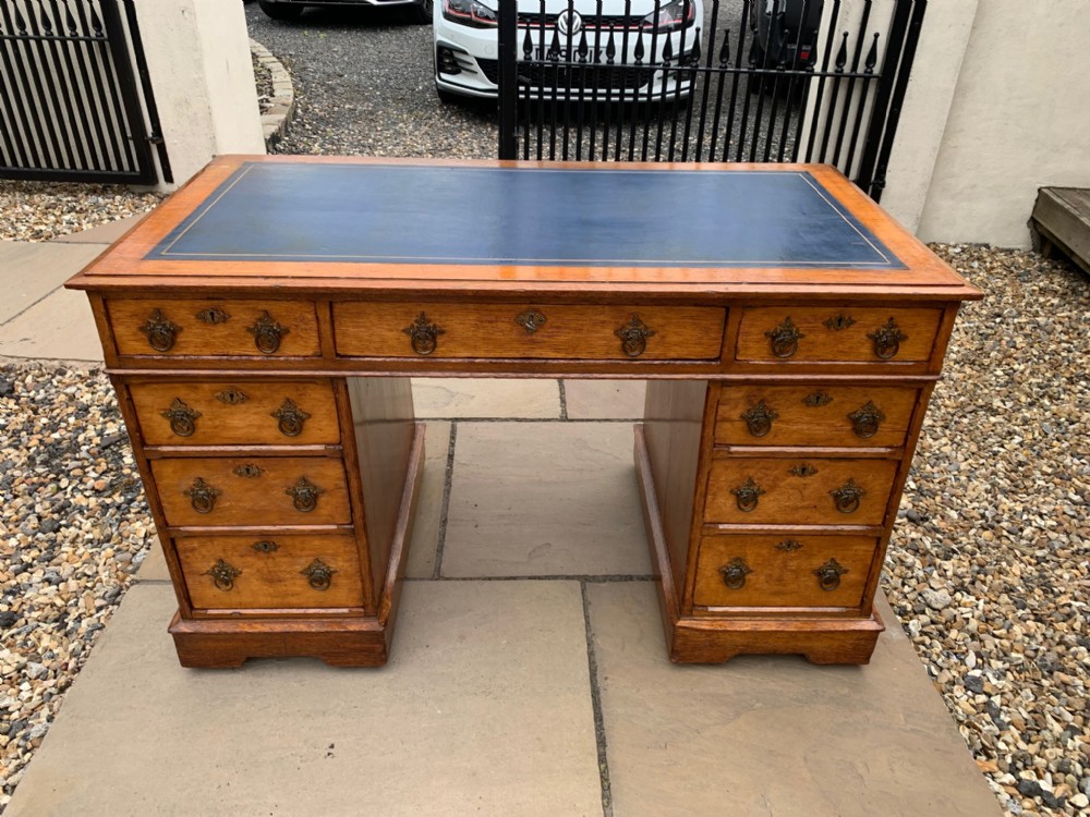 A Victorian Period Gothic Revival oak pedestal desk.