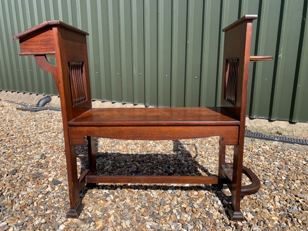 An Arts & Crafts Period walnut hall bench/stick stand by Shapland & Petter Of Barnstaple