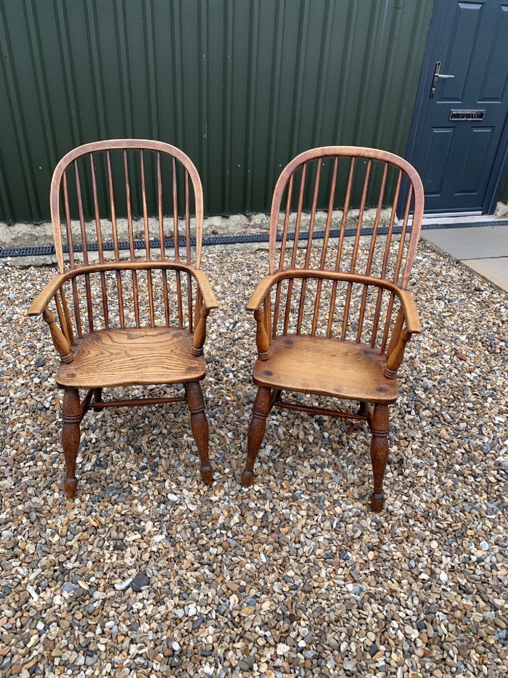 A lovely pair of mid 19th Century ash and elm Windsor arm chairs