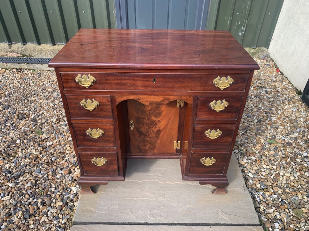 A George III Period mahogany knee hole desk.