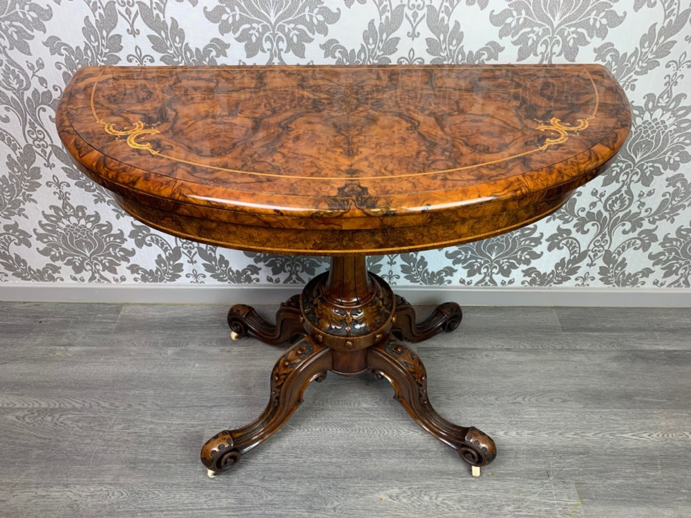 A superior quality Victorian Period burr walnut games table