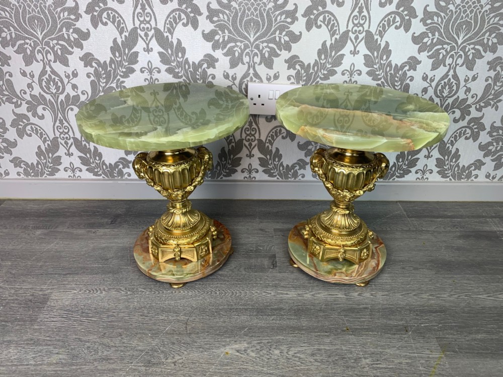 A small pair of French circular onyx and ormolu tables