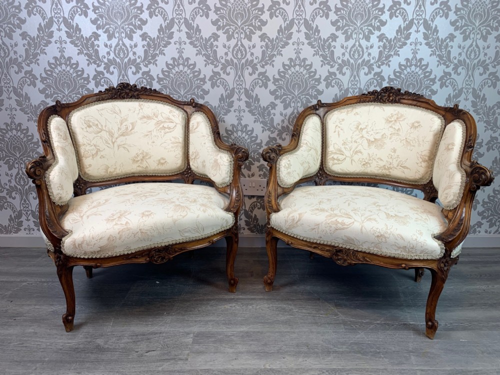 A superb pair of French carved walnut armchairs