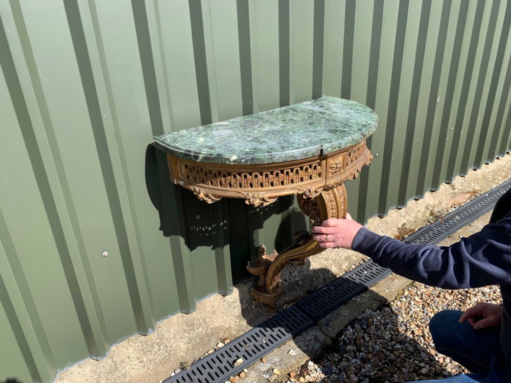 A small French carved gilt wood and marble console table