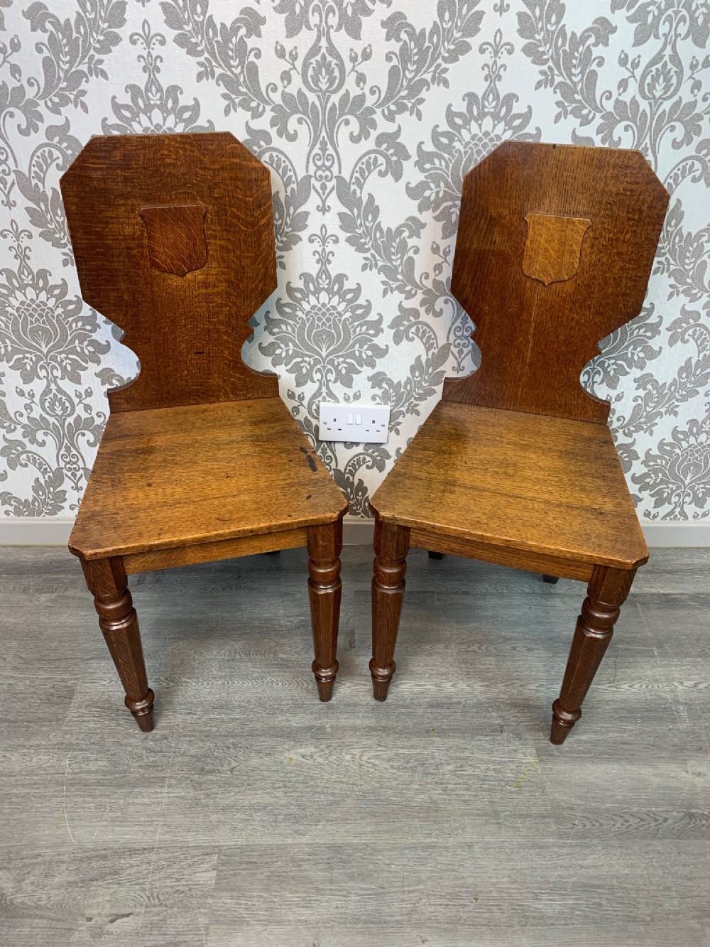 A lovely pair of Early Victorian Period oak hall chairs