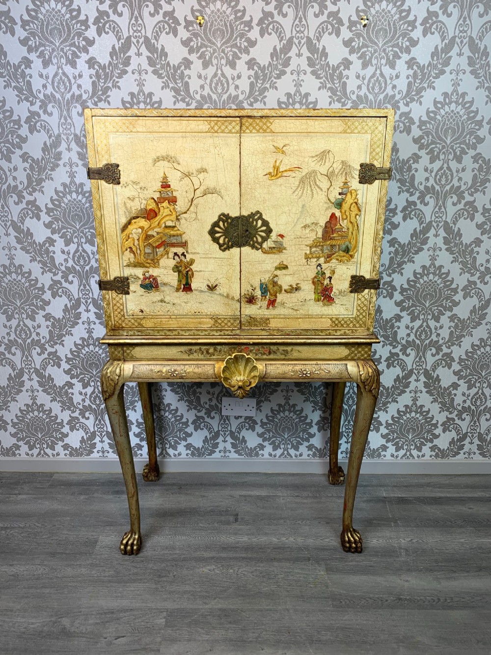 A George I Style Chinoiserie painted and gilded cocktail cabinet