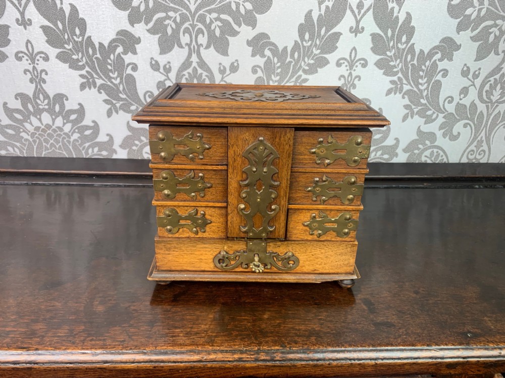 A fine quality walnut and brass banded jewellery casket