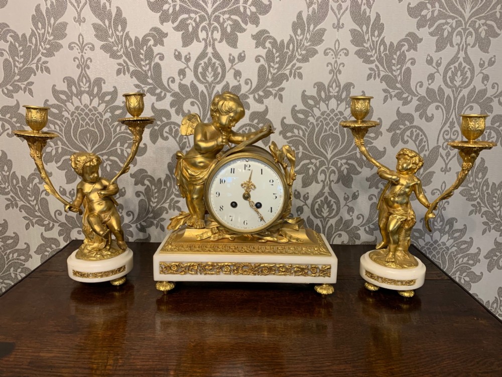 A fine quality French ormolu and marble cherub clock garniture