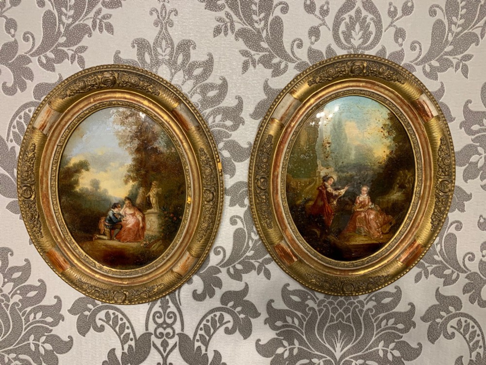 A Pair of 19th Century small oval reverse paintings on glass