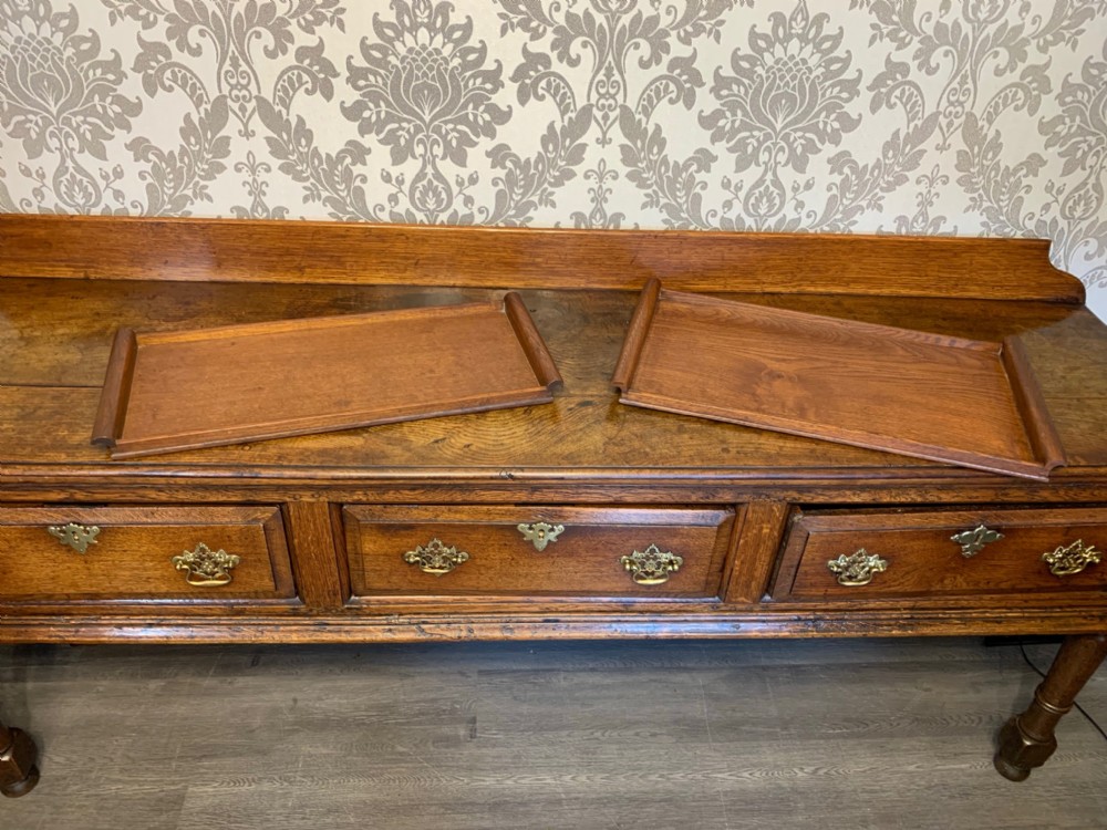 Two similar Arthur Simpson of Kendal oak trays.