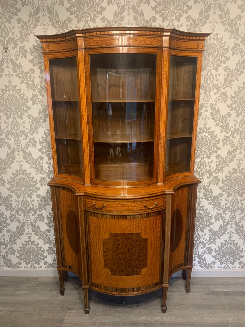 A fine quality Edwardian Period satinwood serpentine display cabinet