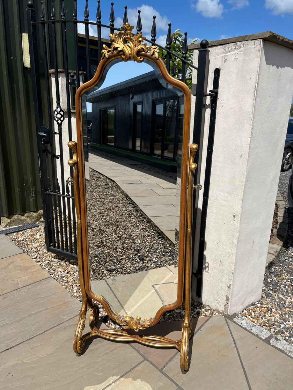 A quality French Style carved gilt wood and walnut cheval dressing mirror