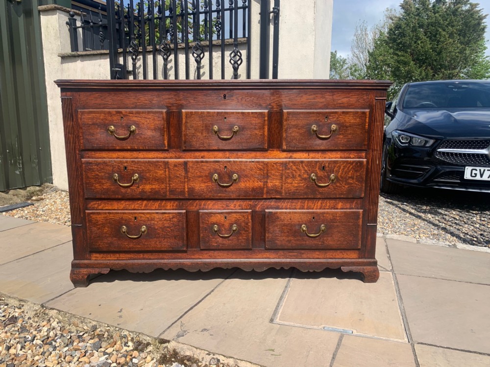 A George III Period oak and mahogany cross banded mule chest