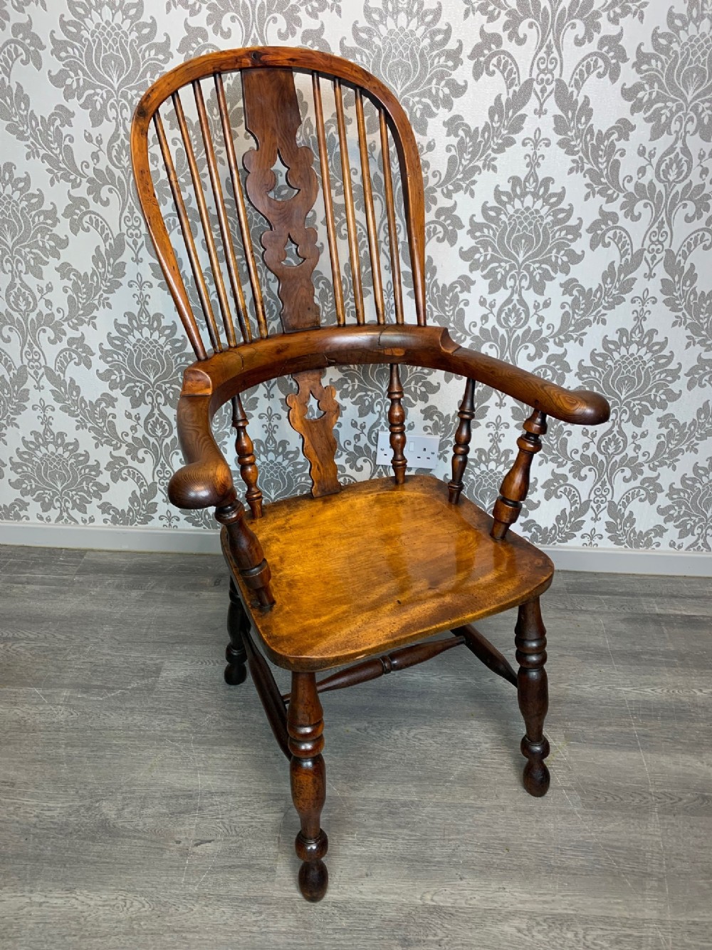 A mid 19th Century yew wood broad arm Windsor Arm Chair 