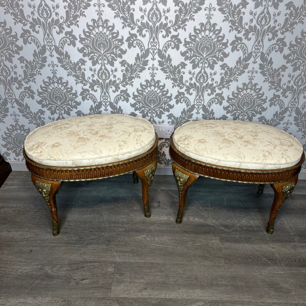 A fine quality pair of French walnut and ormolu mounted stools