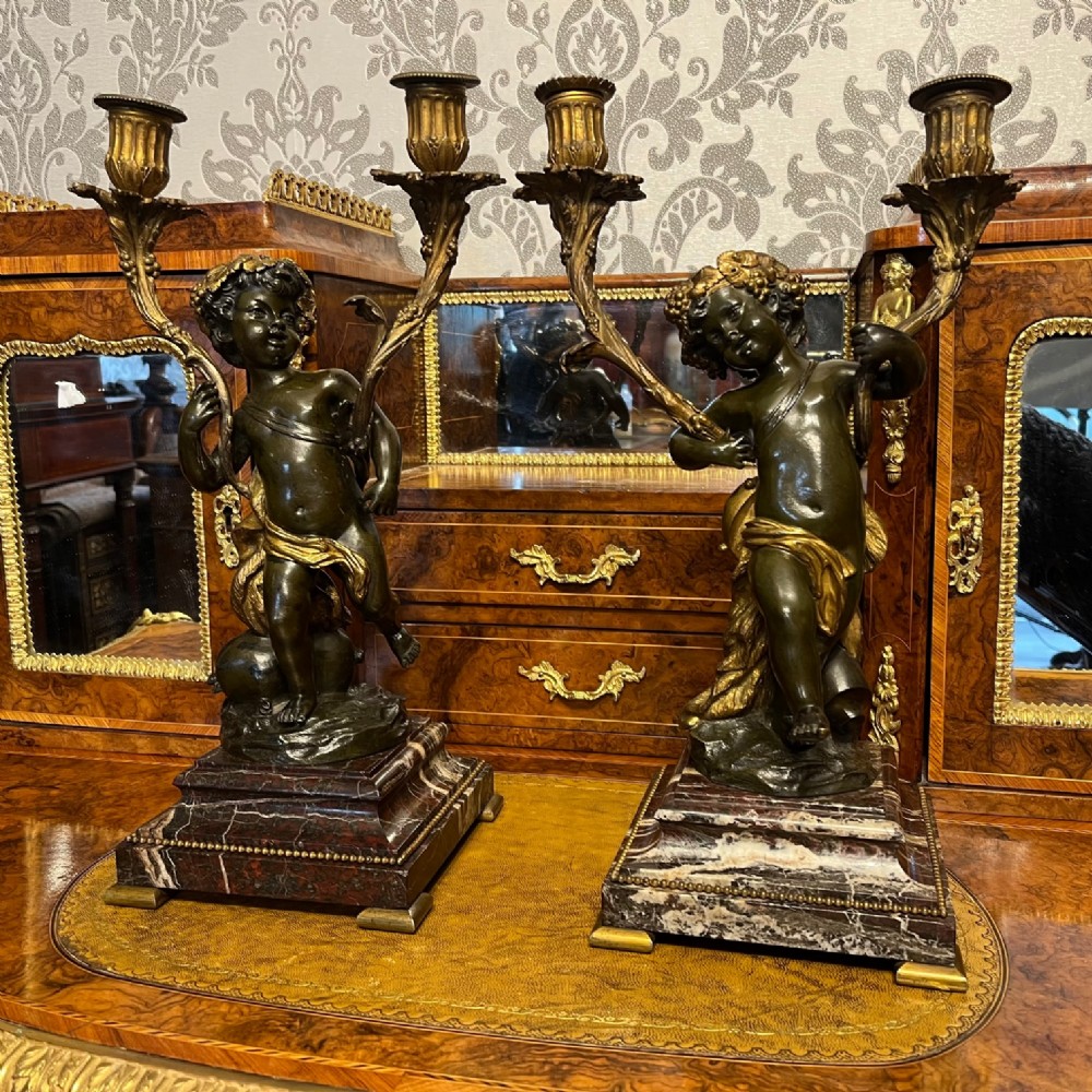 A fine quality pair of 19th Century French cherub candelabra.