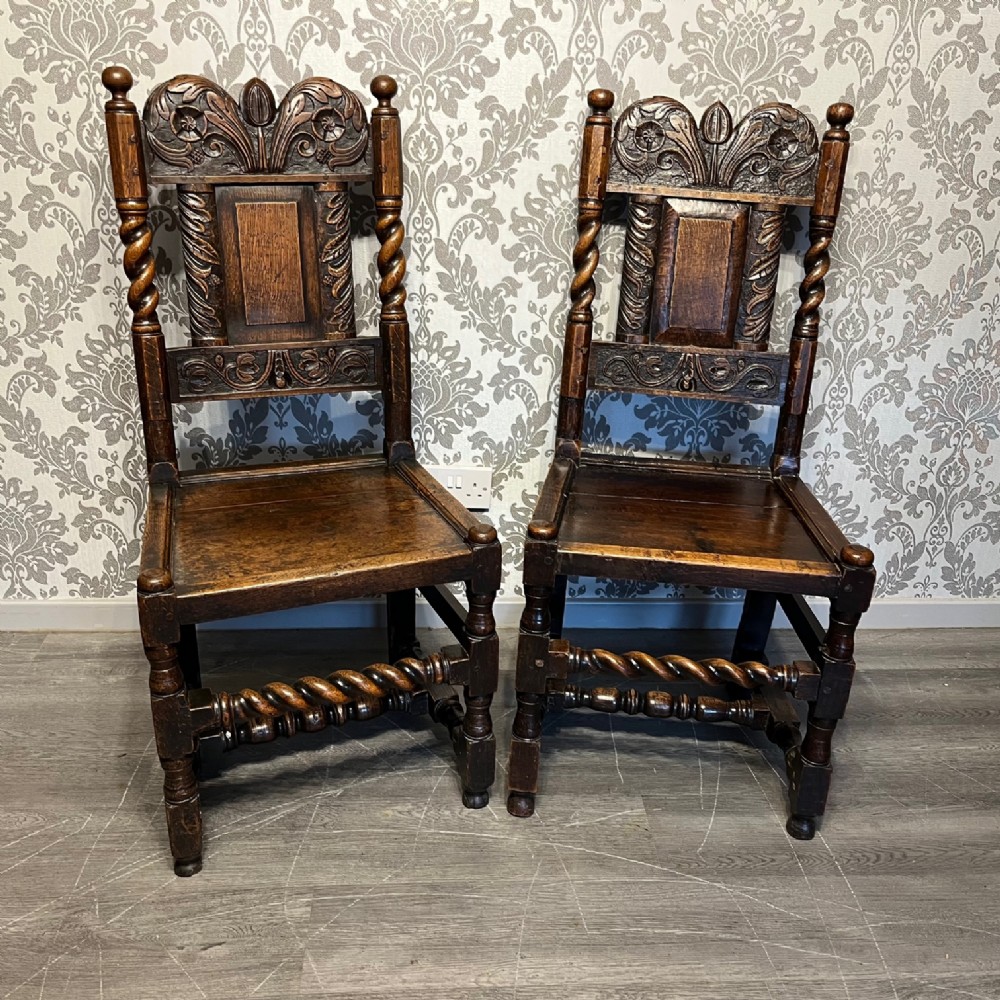 A pair of 17th Century antique oak hall chairs.