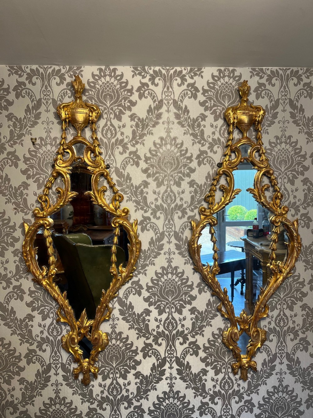 A fine quality pair of French carved gilt wood mirrors