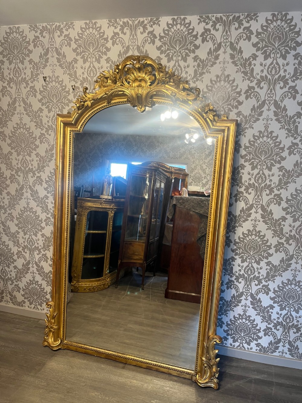 A Beautiful large scale French carved gilt wood and gesso wall mirror.