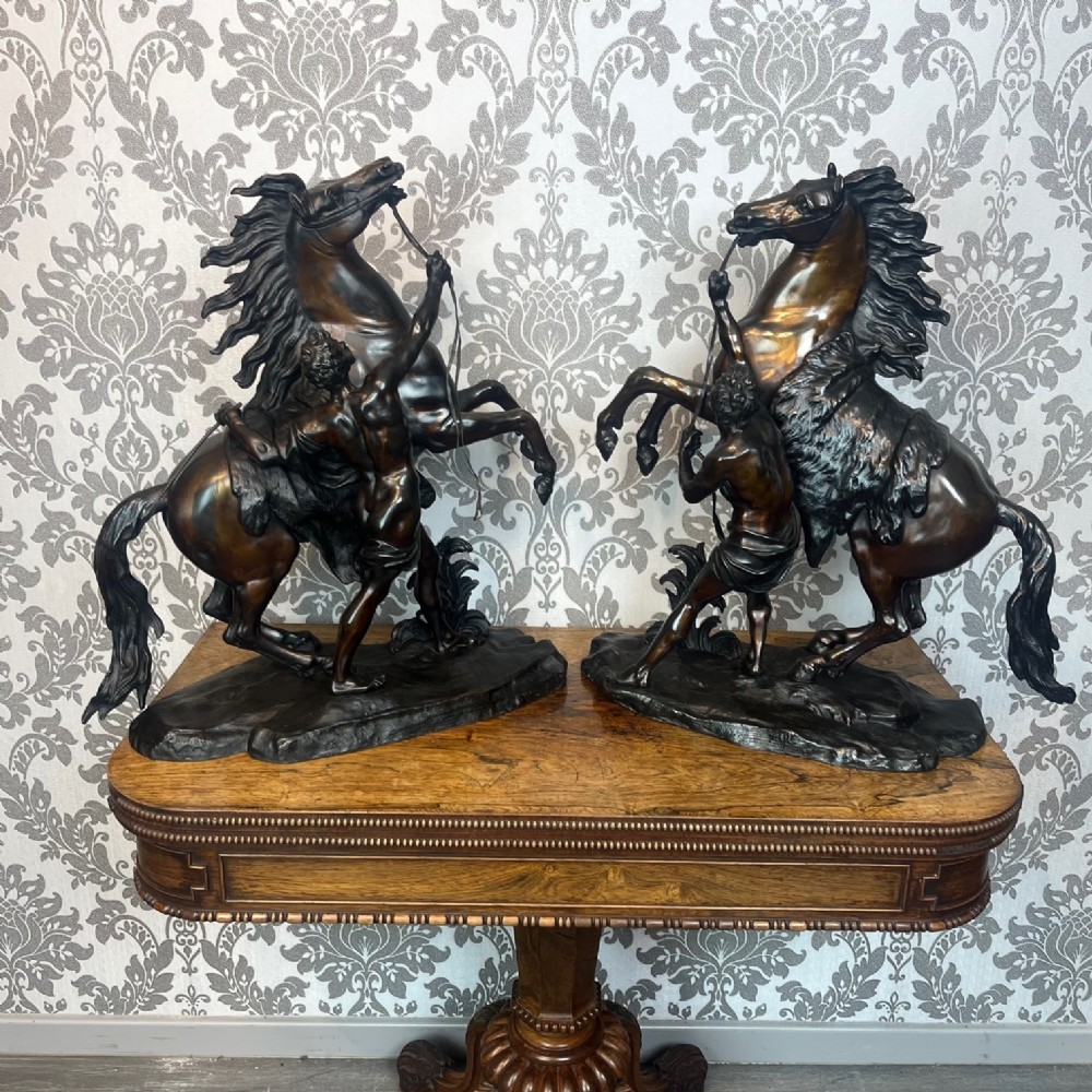 A pair of French Classical 19th Century bronze Marley horses by Coustou