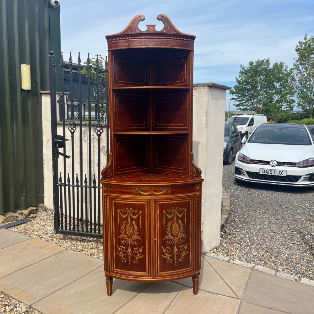 An Edwards & Roberts of London marquetry inlaid corner cabinet