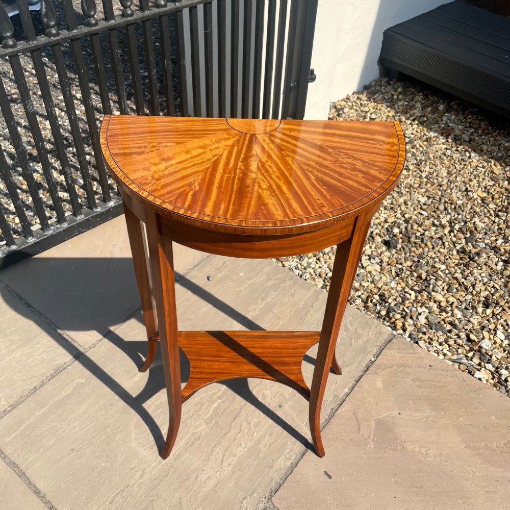 A small Edwardian Period satinwood demi lune table