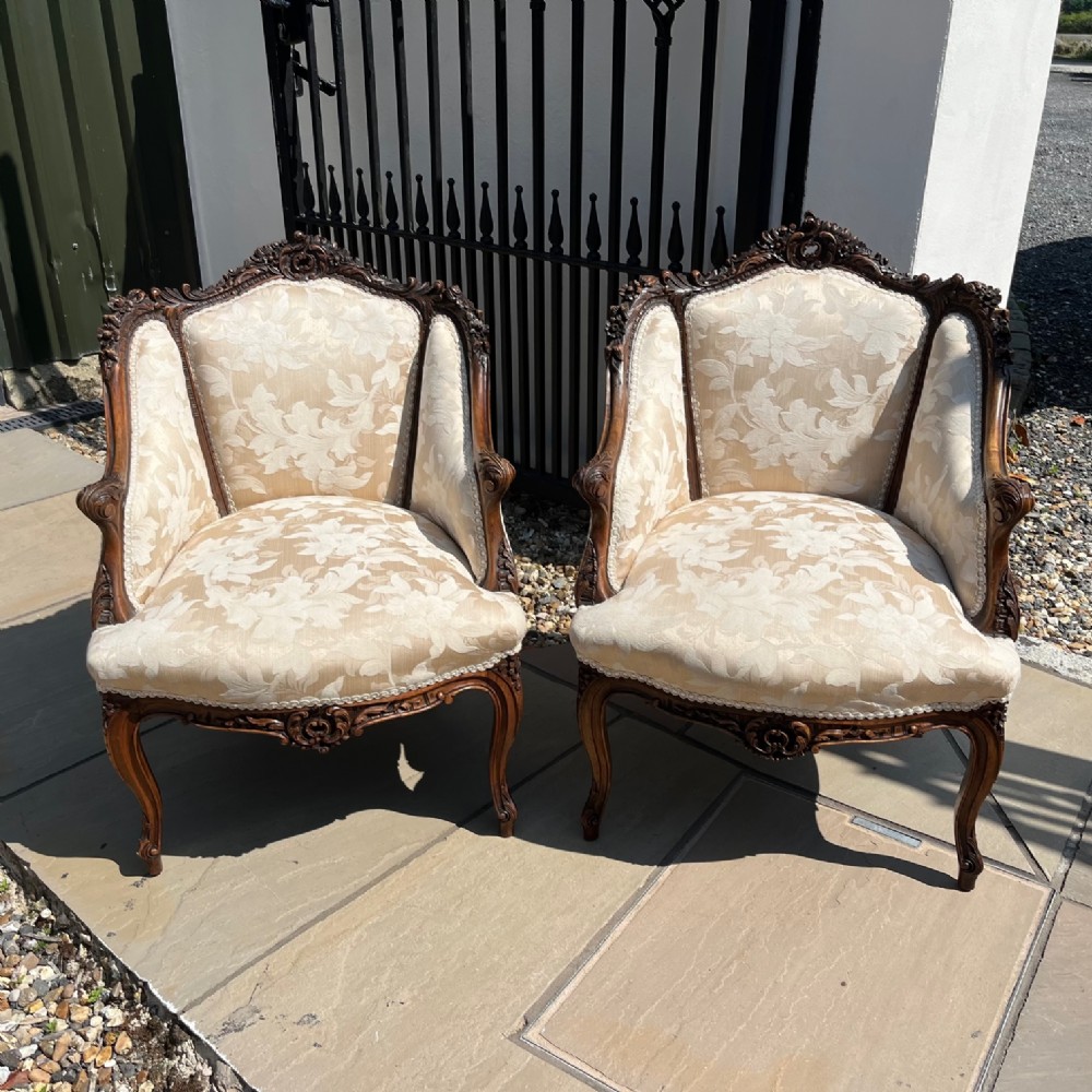 A fine quality pair of French carved walnut salon chairs