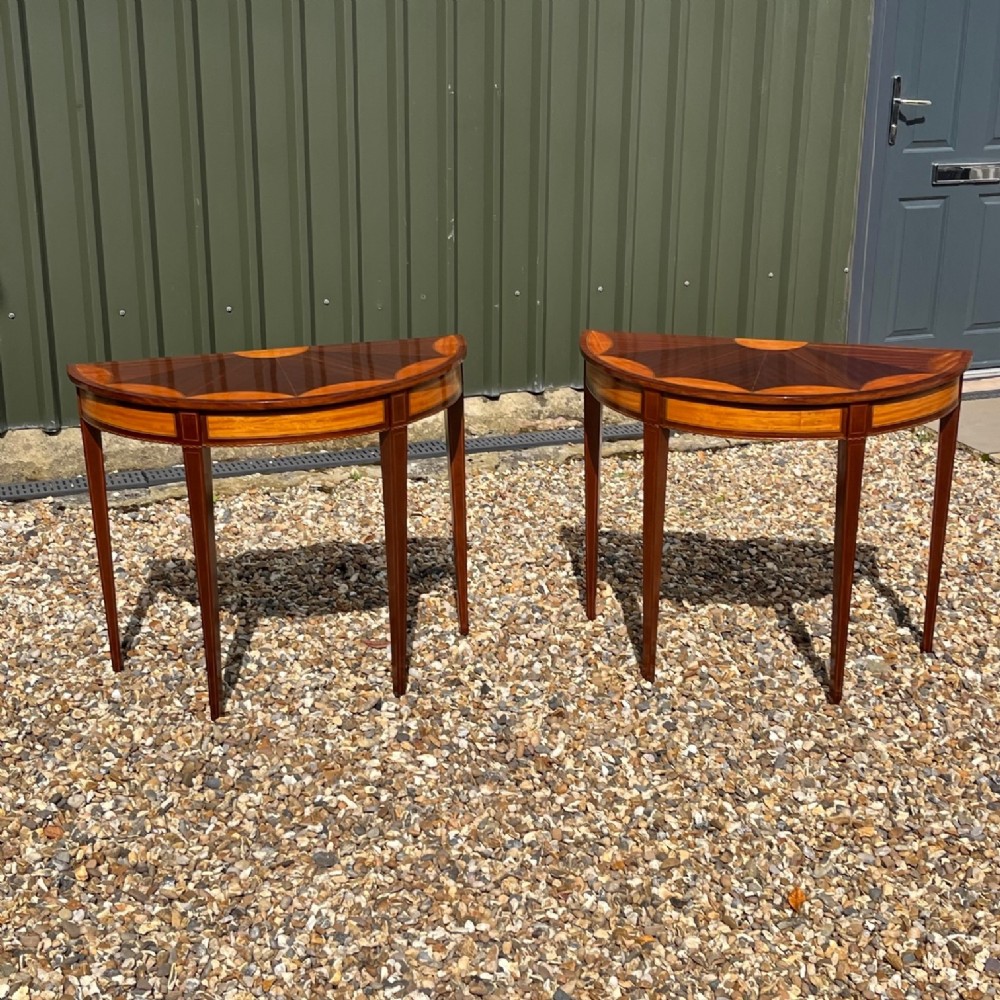A pair of fine quality Edwardian Period mahogany and satinwood demi lune tables