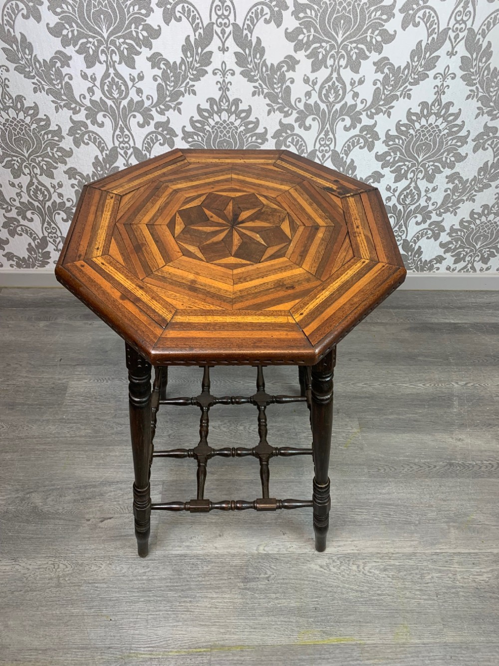 An unusual Aesthetic Period octagonal parquetry inlaid table.