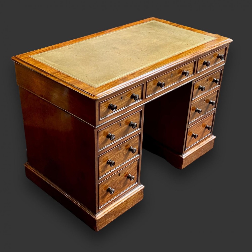A Victorian Period mahogany pedestal desk.
