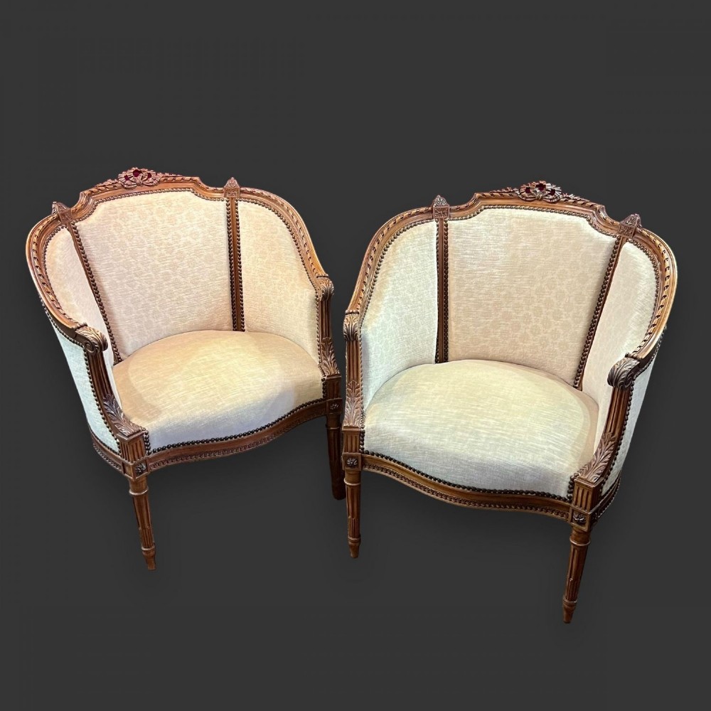 A pair of finely carved walnut French armchairs
