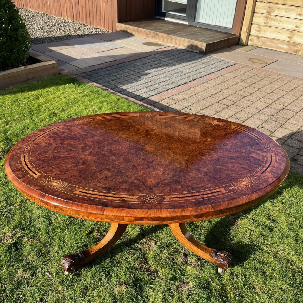 A Victorian Period oval burr walnut and marquetry inlaid coffee table