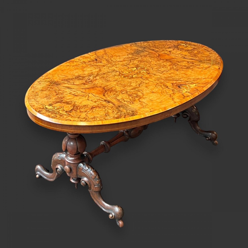 A Victorian Period oval burr walnut coffee table