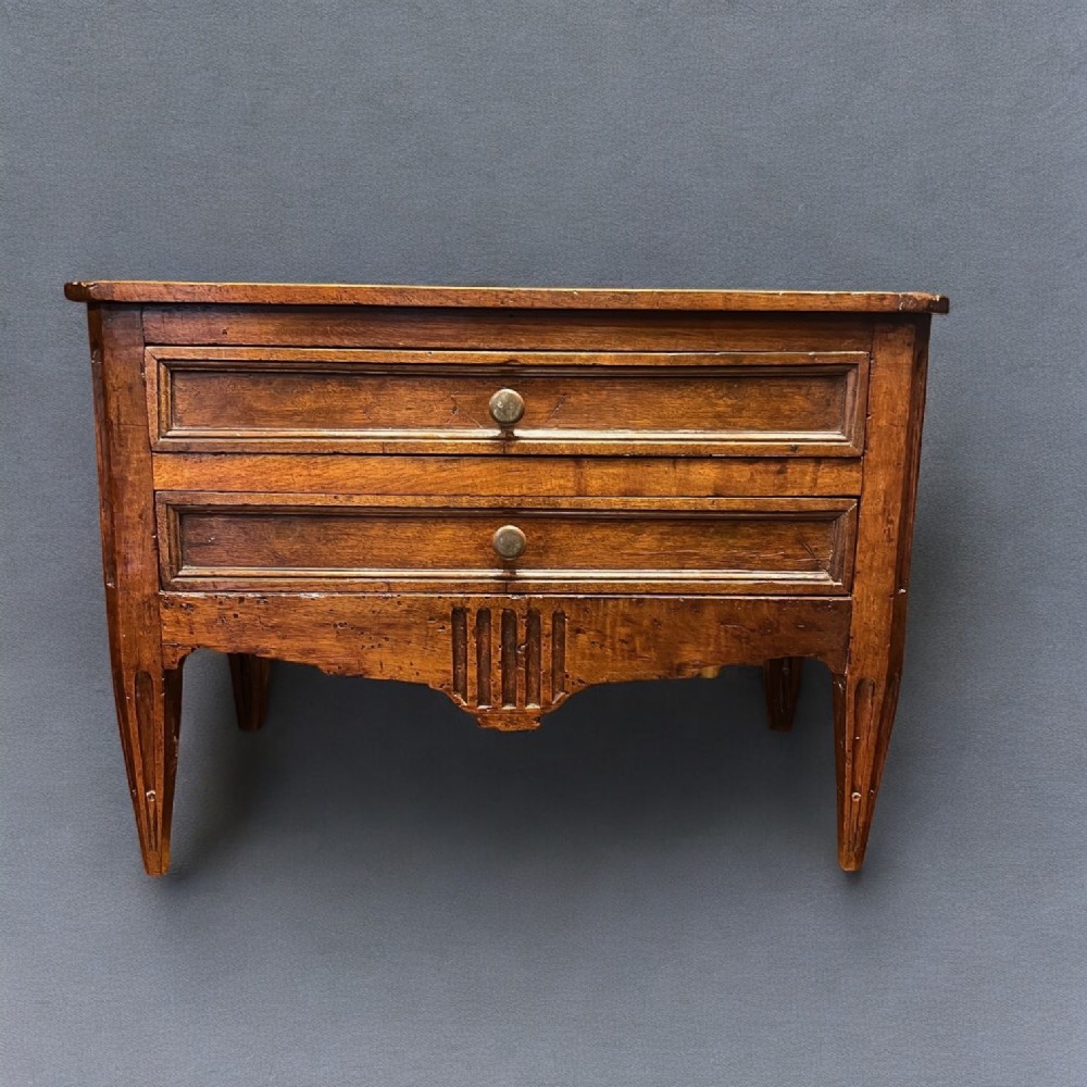 A miniature French walnut commode