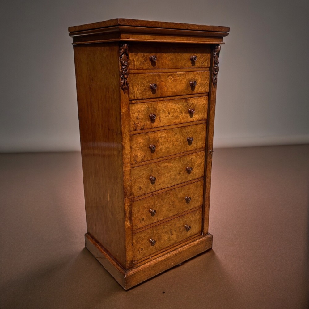 A Mid Victorian Period pollard oak wellington chest by Edwards & Roberts of London.