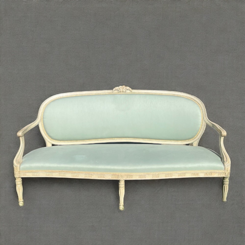 A Louis XVI Style painted French sofa.
