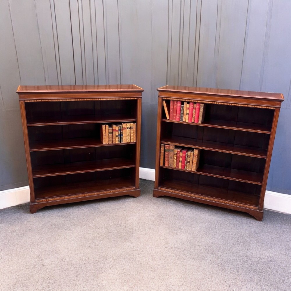 A fine quality pair of Edwardian Period mahogany inlaid open bookcases