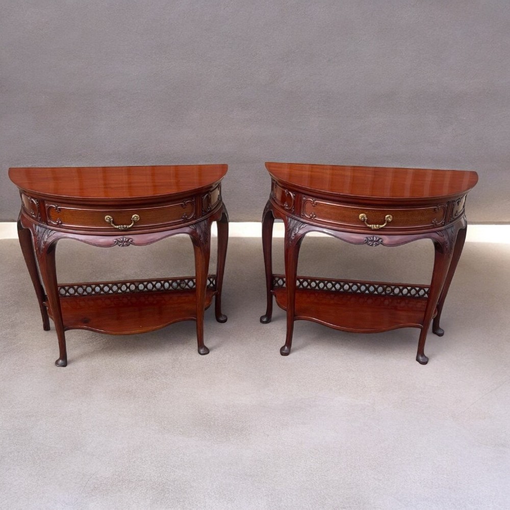 A fine quality pair of Chippendale Revival demi lune console tables