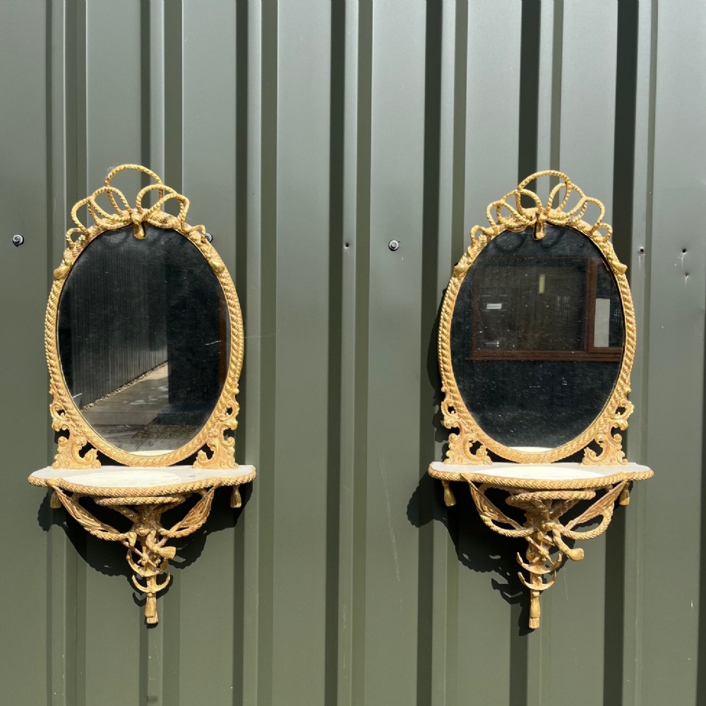 A fine quality pair of French carved gilt wood mirrors
