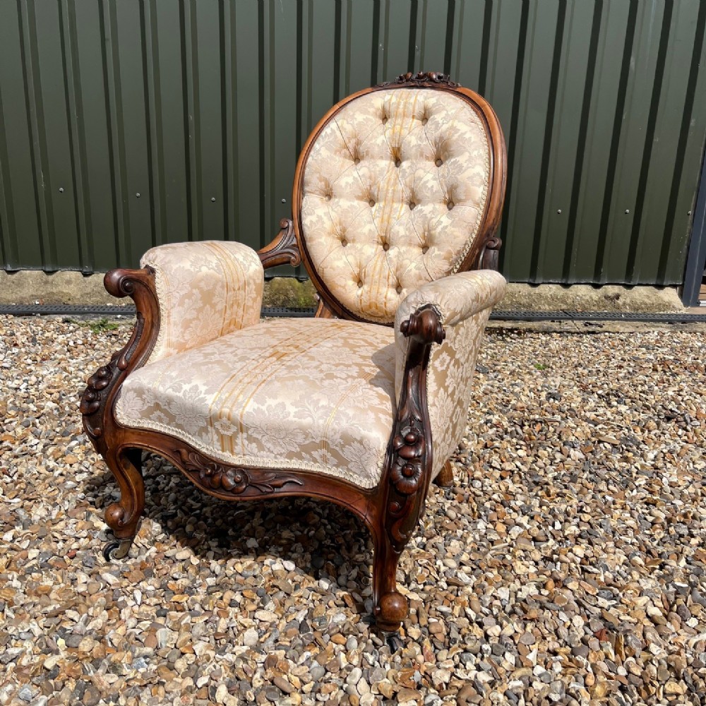 A Victorian Period carved walnut open armchair