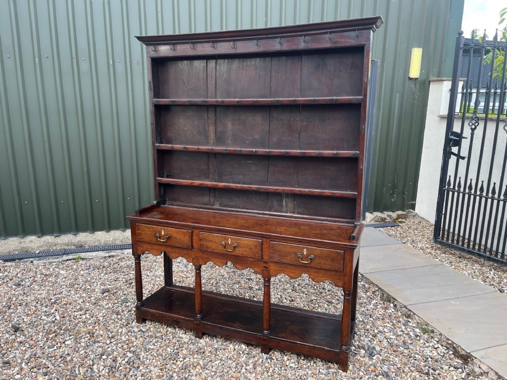 An Early 19th Century Welsh oak pot board dresser and rack.