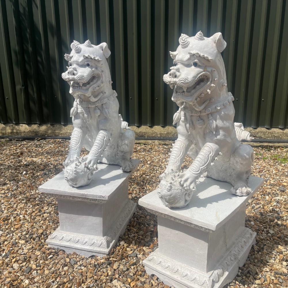 A large and impressive pair of Continental Maiolica glazed dogs of foe