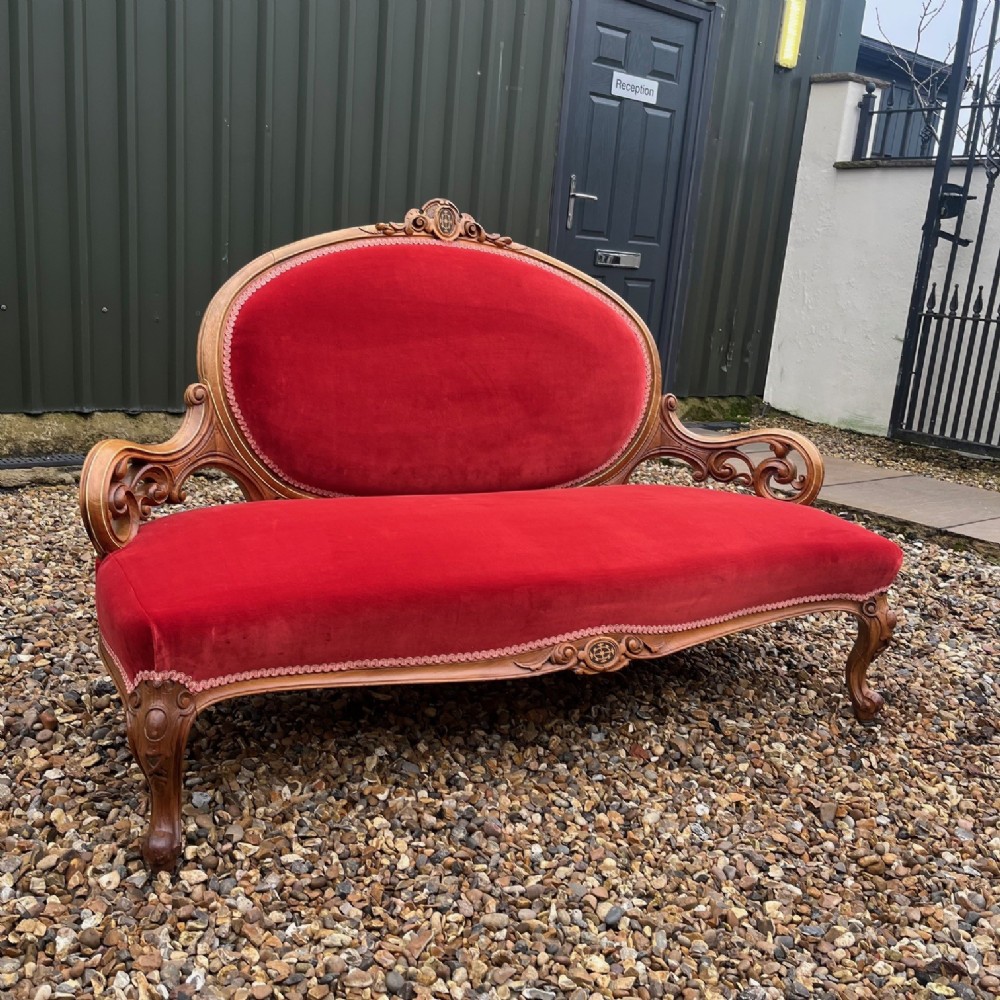 A stunning Victorian Period carved walnut sofa