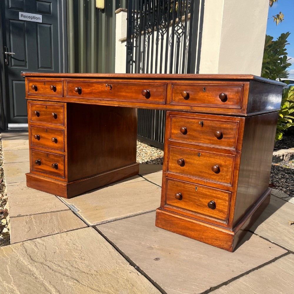 A Victorian Period mahogany pedestal desk.