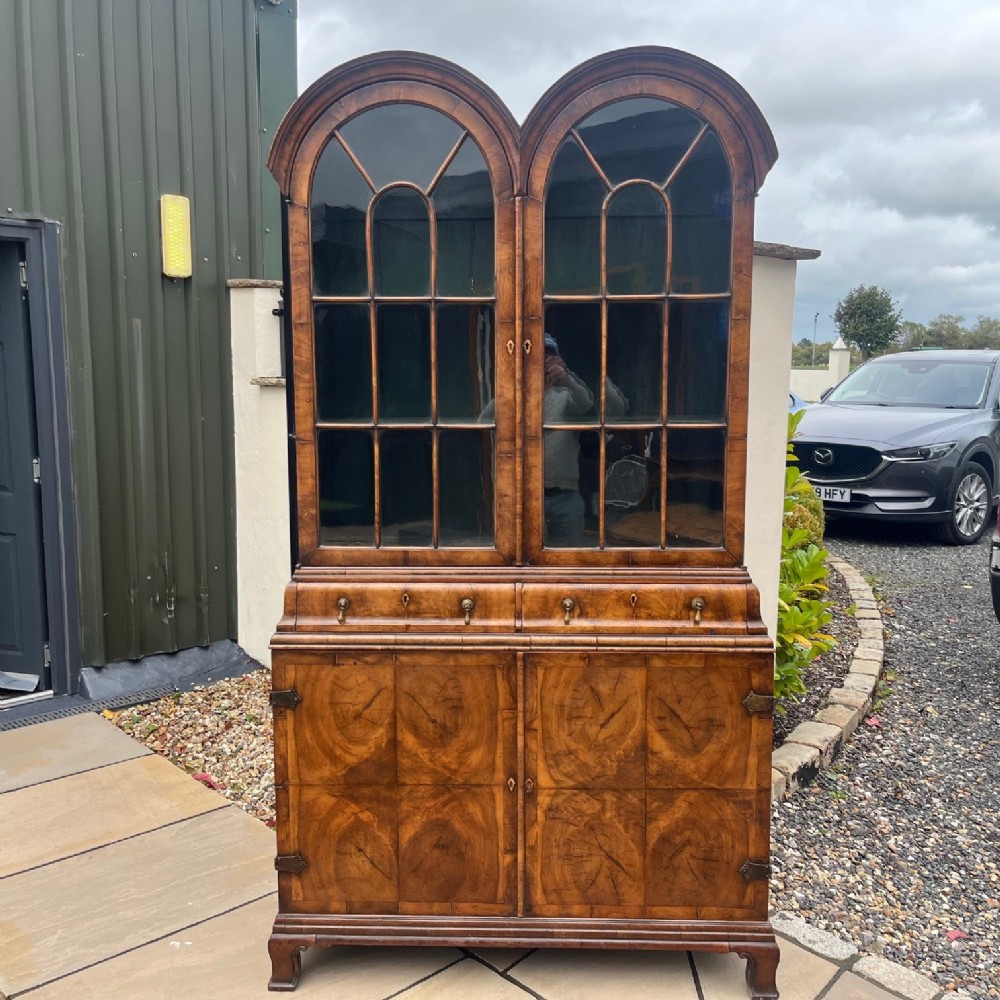 A George I Style walnut double domed cabinet.