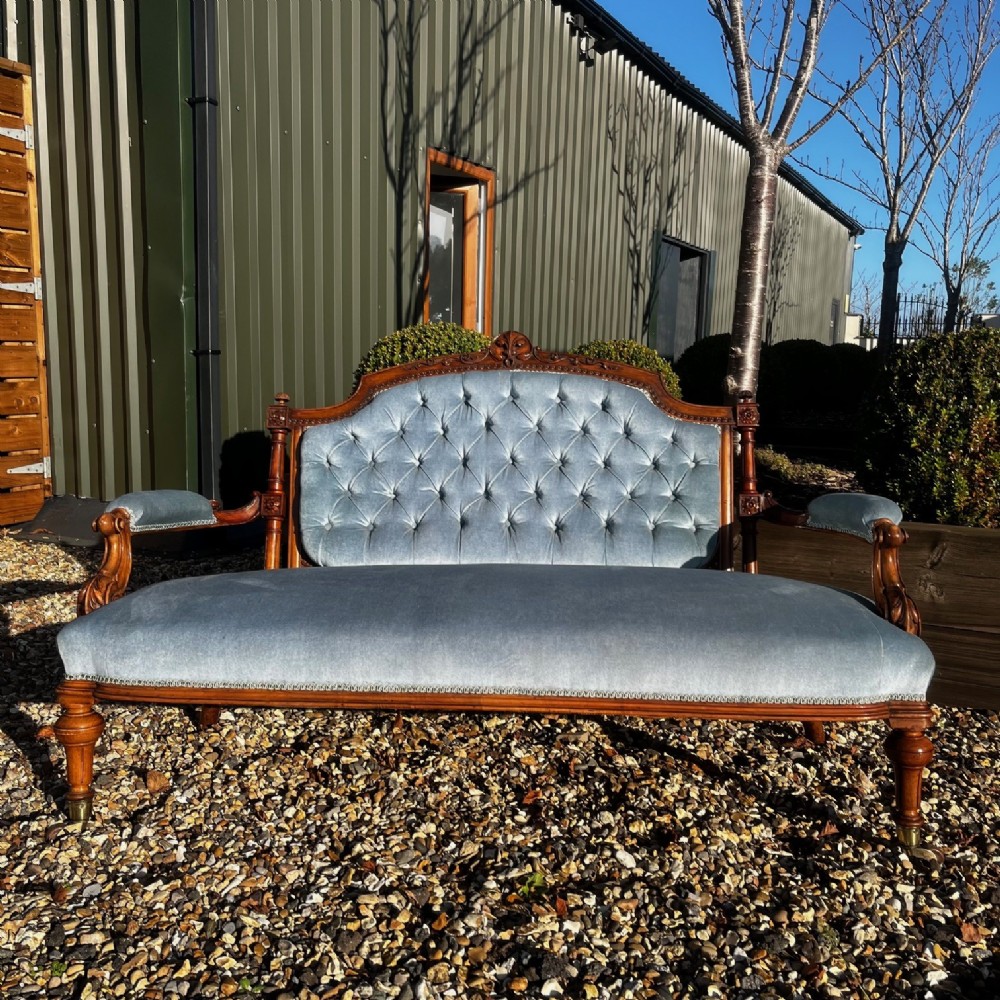 A Victorian Period Walnut Sofa.