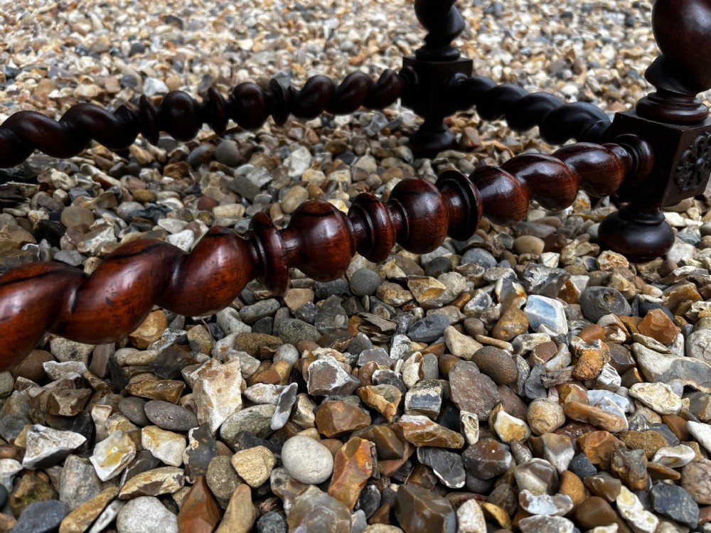 An early 19th-century Portuguese dark rosewood low table featuring spiral barley twist legs, carved rope moulding, and a single drawer with a brass keyhole escutcheon. View II
